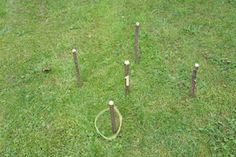 an aerial view of several baseball bats and tees on the ground in a grassy field