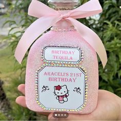 a hello kitty birthday bottle with a pink bow on it's head and name