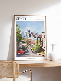 the seattle skyline is framed in an art print on a shelf next to a chair