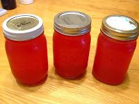 three jars are lined up on a table