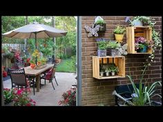 an outdoor dining area with potted plants on shelves and patio furniture in the background