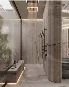 the interior of a modern bathroom with marble walls and flooring is lit by recessed lighting