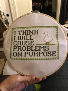 someone is holding up a cross - stitch pattern that says i think i will cause problems on purpose