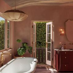 a bath tub sitting next to a window in a bathroom