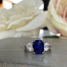 🐕 Big deals! Elongated Cushion Cut Sapphire Engagement Ring With Trillion Accents, Moissanite Ring In 14K White Gold #5737 #6800 #6801 only at $509.00 Hurry. #WhiteSapphire #ElongatedCushion #BrideToBe #SapphireRing #AnniversaryGift #EngagementRing #GiftForHer #BlueSapphire #WeddingRing #WhiteGold Cushion Cut Sapphire Ring, Elongated Cushion Cut Engagement Ring, Engagement Ring Blue Sapphire, Engagement Ring Blue, Ring Blue Sapphire, Cushion Halo Engagement Ring, Elongated Cushion Cut, Blue Sapphire Engagement Ring, Vintage Engagement Rings Sapphire