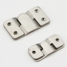 pair of stainless steel door hinges on white background