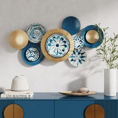 a blue cabinet with plates on it and a potted plant in front of it