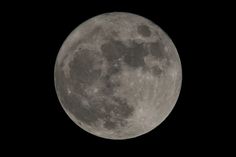 the full moon is seen in the dark sky