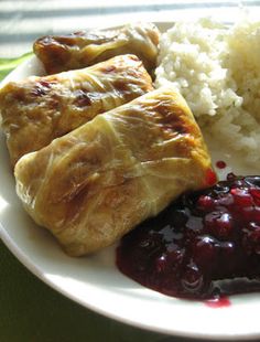 a white plate topped with meat, rice and cranberry sauce