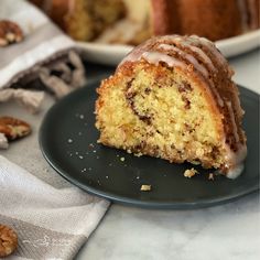 a bundt cake with icing and walnuts on a plate