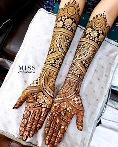 two hands with henna designs on them