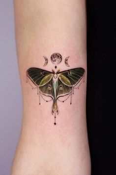 a small moth tattoo on the side of a woman's right leg and foot