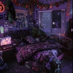 a bedroom decorated in purple and black with decorations on the ceiling, bedding, and windows