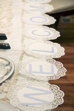 the table is lined with lace doily and place cards for guests to write their names