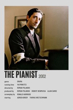 a man in a suit sitting at a piano