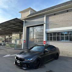 a black car parked in front of a building