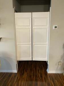 an empty room with two white doors in it