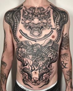 a man with tattoos on his chest and back