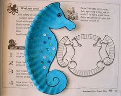 a blue sea horse sitting on top of a piece of paper