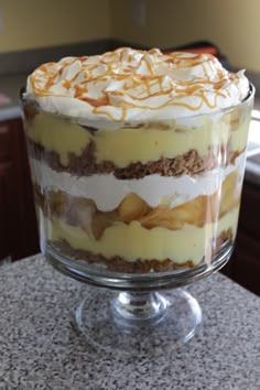 a layered dessert in a glass dish on a counter