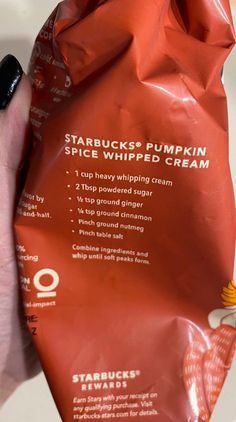 someone is holding a bag of starbuck's pumpkin spice whipped cream in their hand