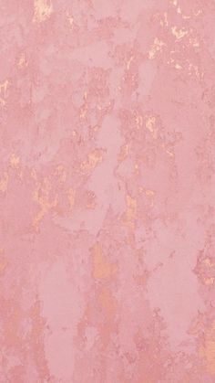 a pink wall with gold paint on it