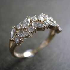 a gold ring with many diamonds on it