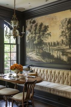 a dining room with a bench and painting on the wall