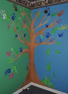 a child's room painted with hand prints and a tree