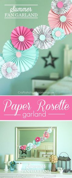 paper rosette garlands hanging from the ceiling in a girls'bedroom with pink and blue