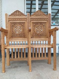 two wooden chairs sitting next to each other