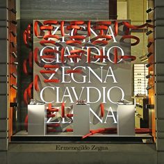 a display window with red scissors in it's display case and the words, zeigia giardio, zigna