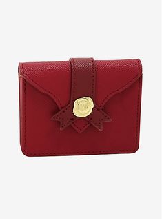 a red card case with a gold buckle on the front and two small cards in it