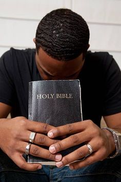 a man holding a bible in his hands