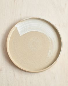 a white plate sitting on top of a wooden table