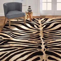 a zebra print rug with a chair in the corner next to it and a window