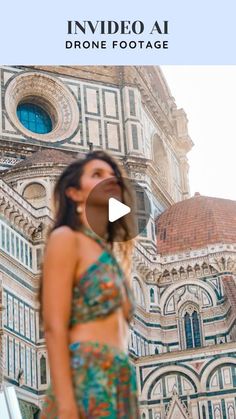 a woman standing in front of a large building