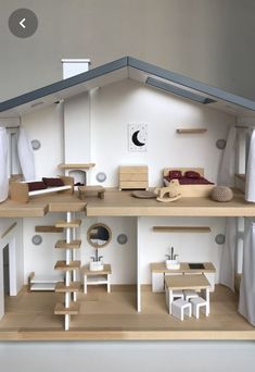 a doll house with furniture and accessories on display