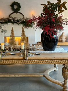 a dining room table with candles and christmas decorations