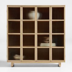 a wooden bookcase with glass doors and shelves