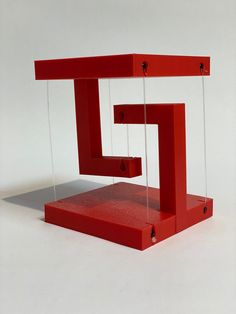 a red sculpture sitting on top of a white table