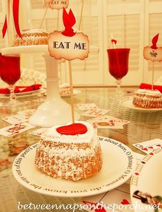 a table topped with cakes and desserts covered in frosting