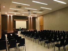 an empty conference room with rows of chairs