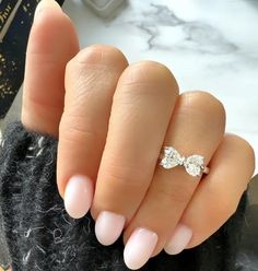 a woman's hand with a ring on it