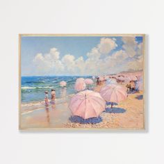 there are many pink umbrellas on the beach by the water and people in the sand