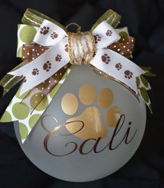 a glass ornament with a dog's paw and name on the front