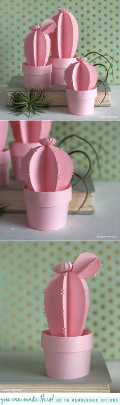 there are three pictures of pink paper flowers in the shape of cactuses on display