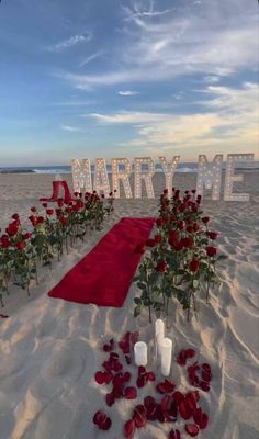 a red carpeted beach with roses and candles on it