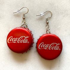 coca - cola bottle cap dangle earrings on white background