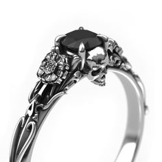 Beautifully crafted Edwardian vintage style filigree skull engagement ring with Marigold accents. Features a vintage patina finish, polished.    This ring features a ~4.8-5mm round Black Diamond center stone. Message us about a custom idea! 1820s Engagement Ring, Angel Wing Engagement Ring, Black Gold Ring Engagement, Gothic Style Wedding Rings, Black Promise Ring, Emo Promise Rings, Spider Engagement Ring, Black Promise Rings For Her, Dark Promise Rings